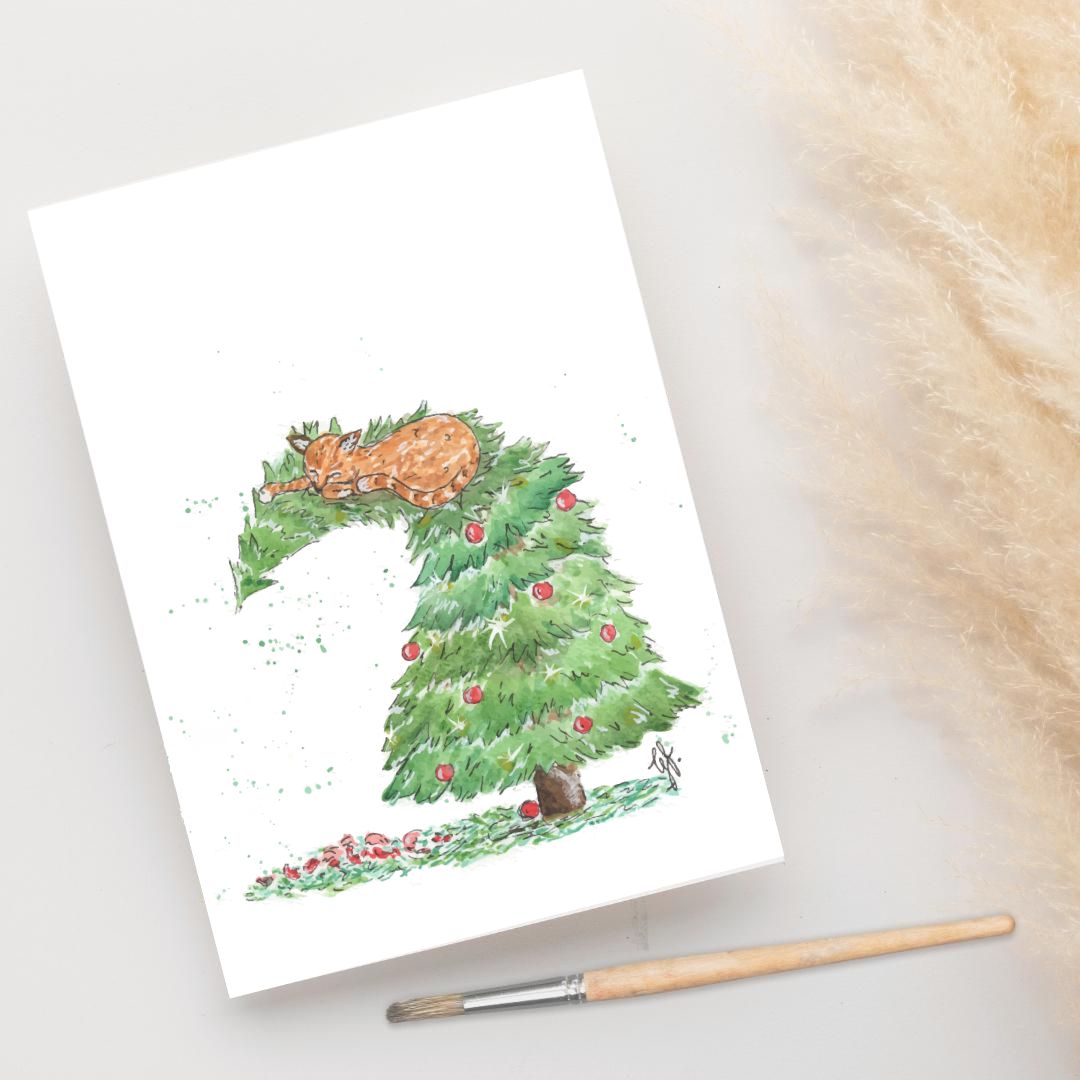 Foto van een ansichtkaart met een illustratie van een kat die op de piek van de kerstboom ligt door a Girl in the Field