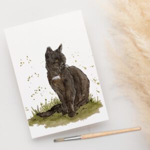 Foto van een ansichtkaart met aquarelschildering van Charlie, de zwarte kater